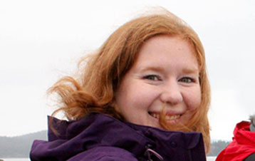 Mica with cloudy and windy skies behind her