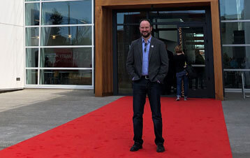 Michael standing on red carpet in front of building