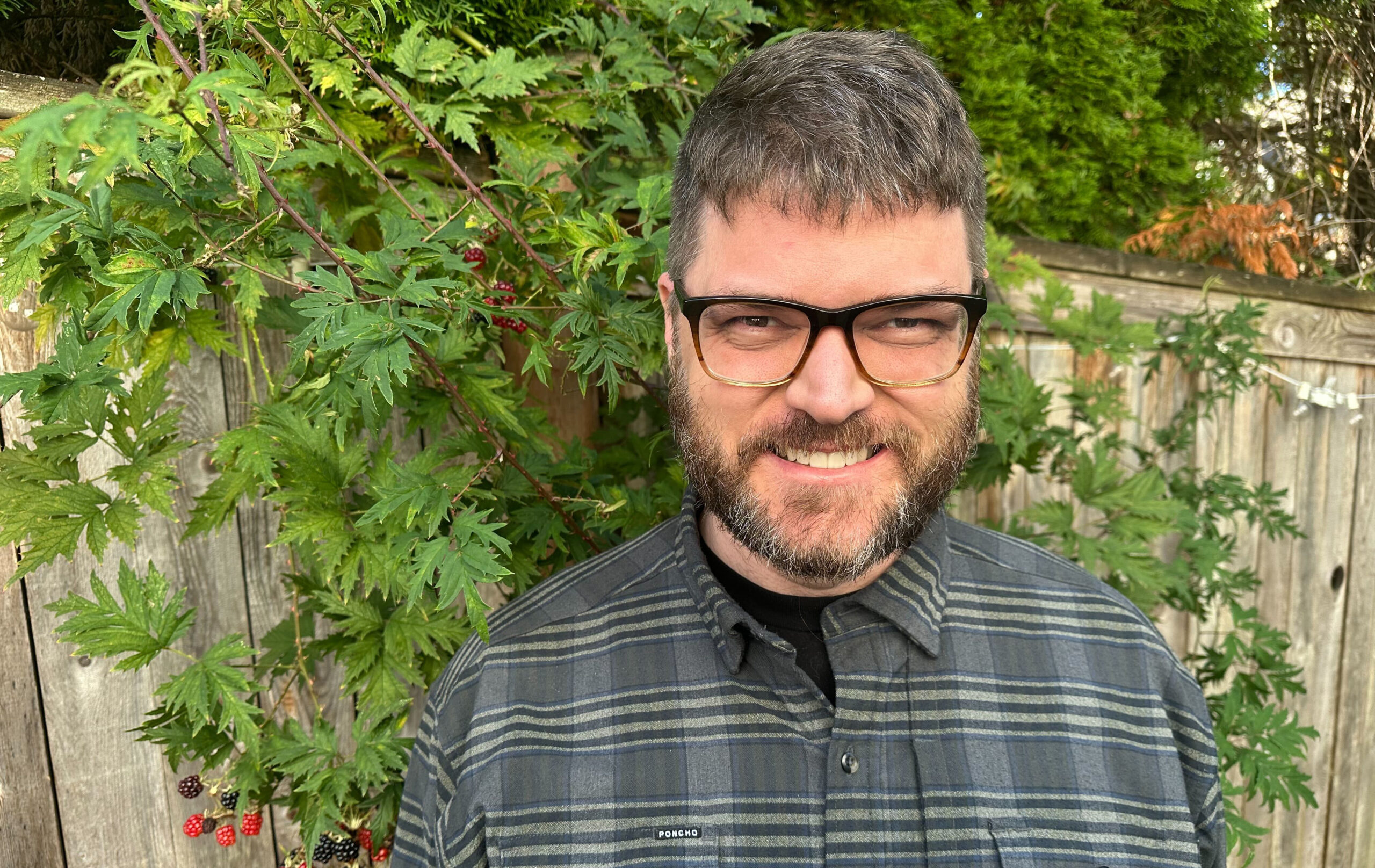 Justin with wooded scenery behind him
